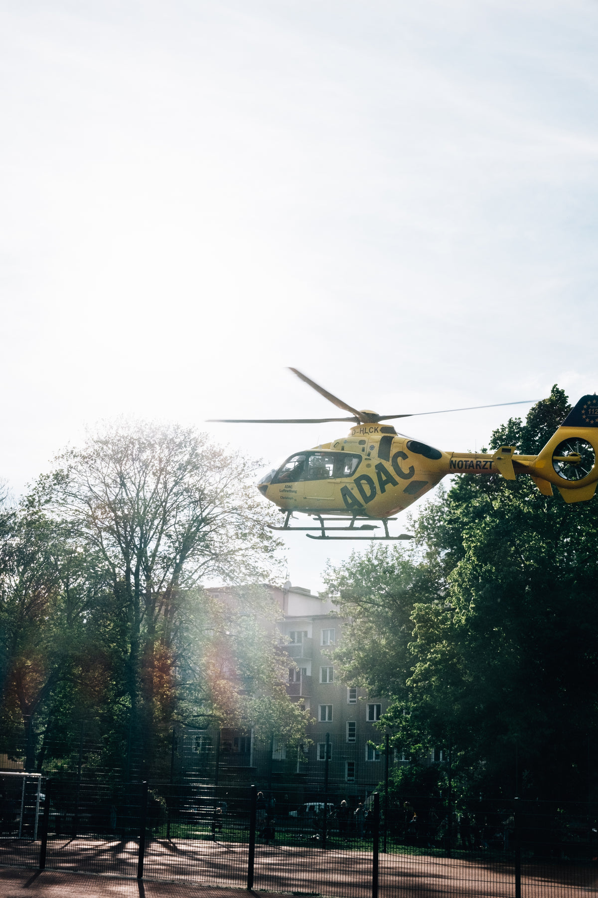 yellow helicopter lands in town