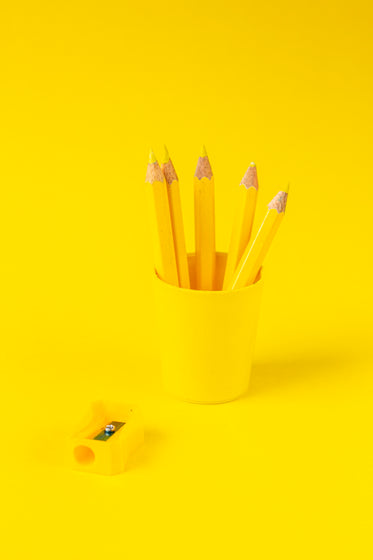 yellow pencils cup and sharper on yellow background