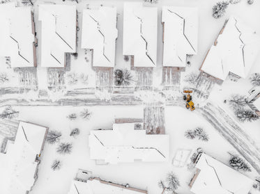 yellow snow plow clearing suburban streets