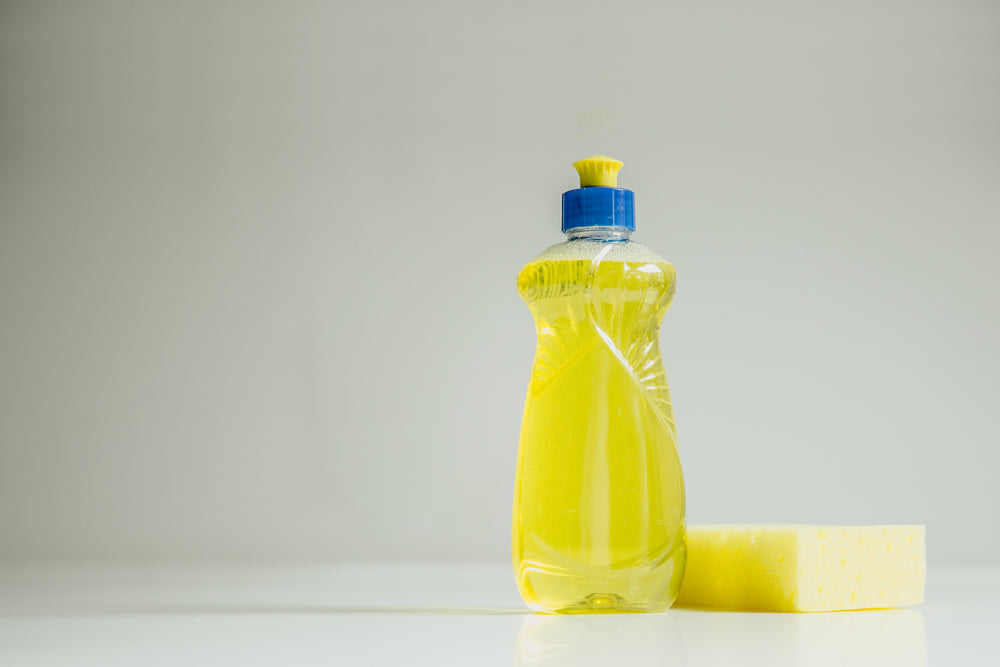 yellow soap and cleaning sponge