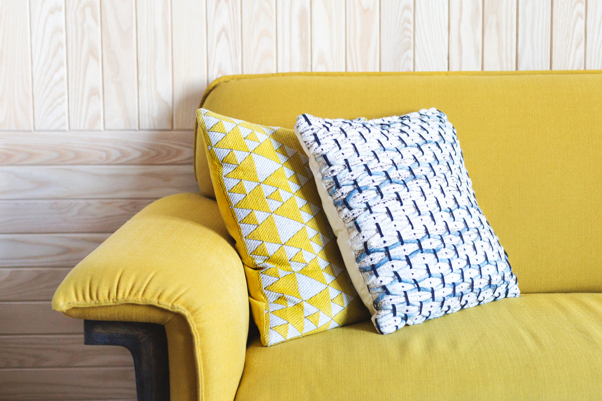 yellow sofa with throw pillows