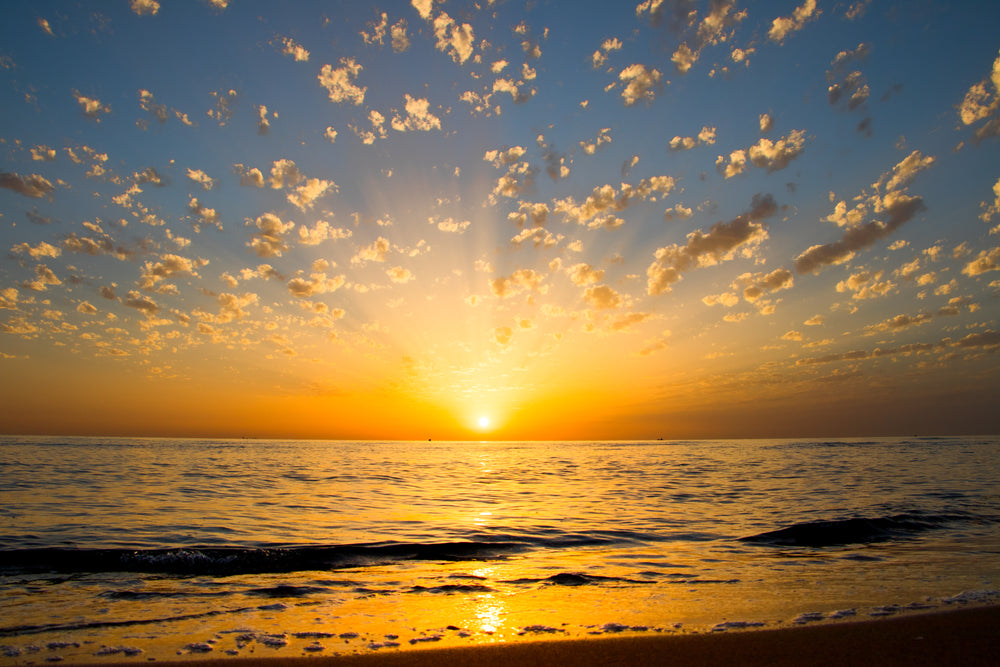 yellow sunrise reflections over the water