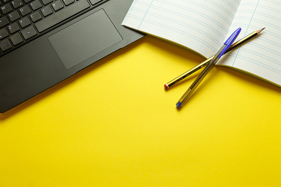 Browse Free HD Images of Yellow Table With Lined Notebook And Computer