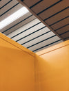 yellow walls with slatted ceiling