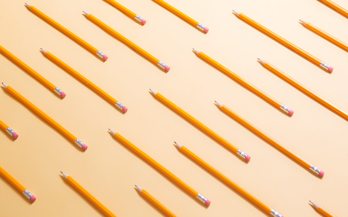 yellow writing pencils arranged in lines