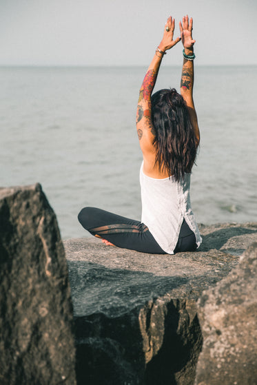 yoga posing tattooed woman