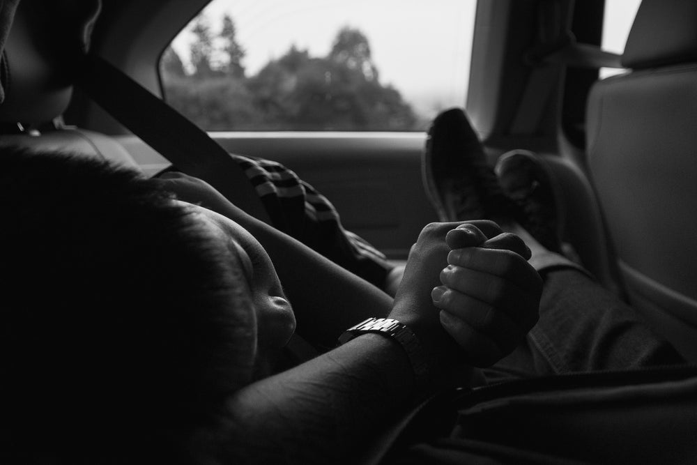 young boy naps during car ride