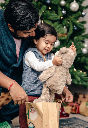 young boy receives teddy bear for christmas