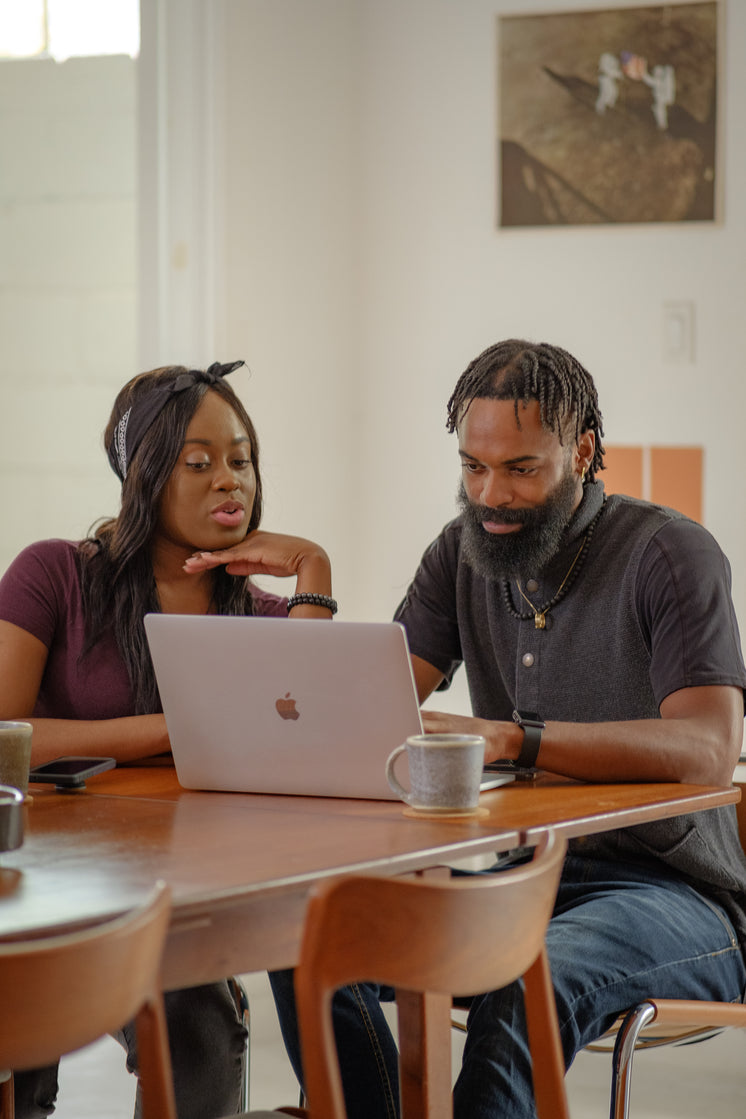 Young Couple Sharing A Laptop