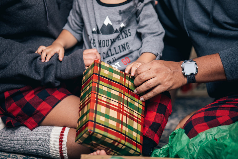 young family opens christmas presents