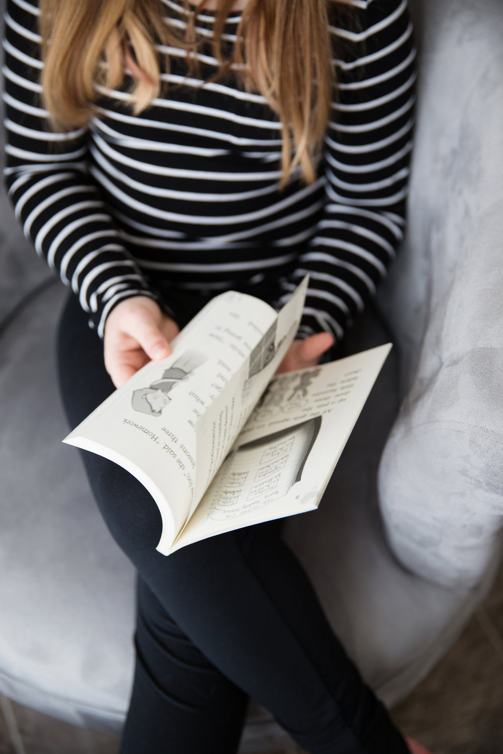 young girl flipping pages of a book