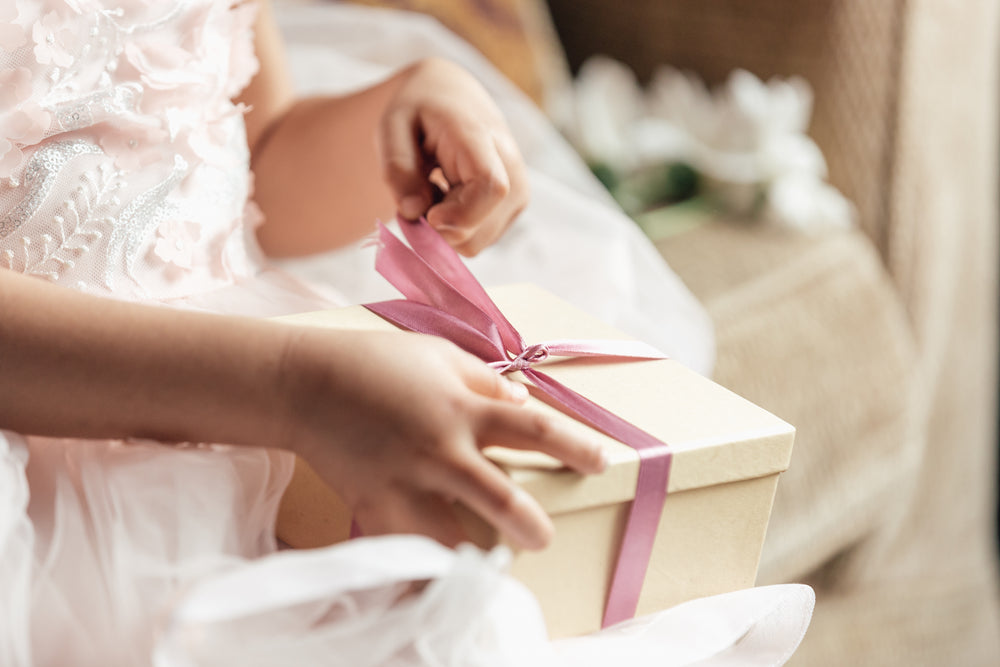 young girl opening gift