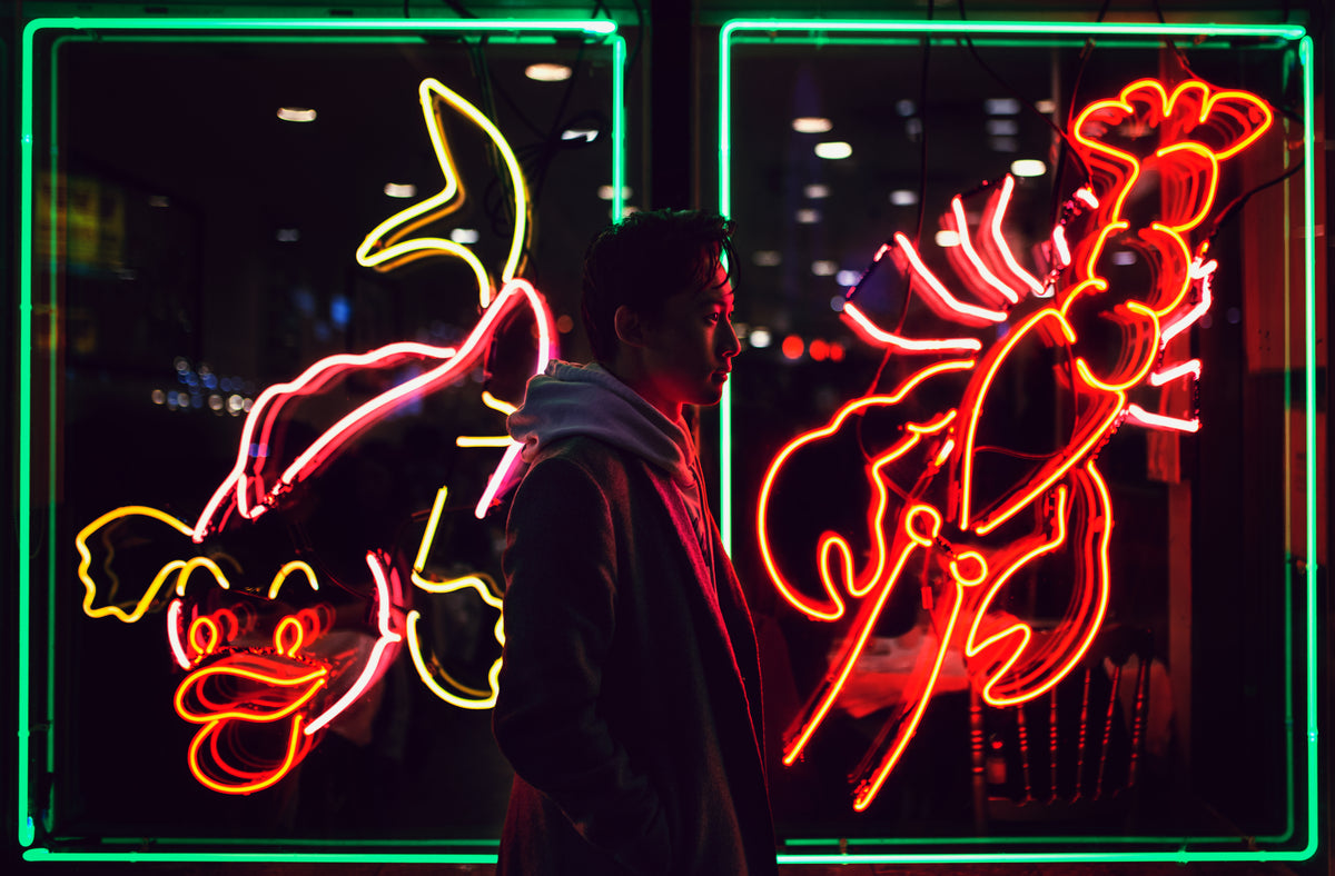 young man in front of neon lights