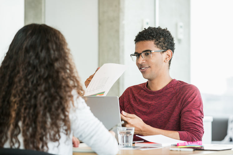 young-man-in-meeting-going-over-reports.