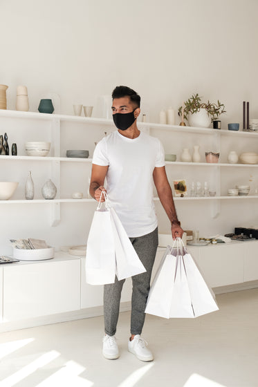 young man leaves store with shopping