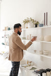 young man looks at home goods in store