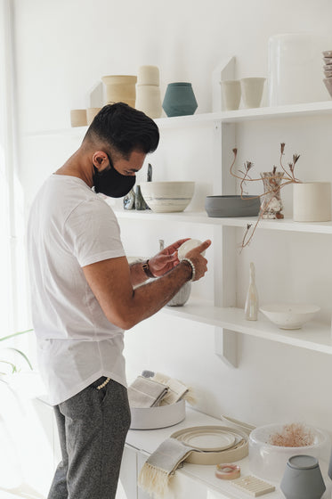 young man looks at merchandise in local store