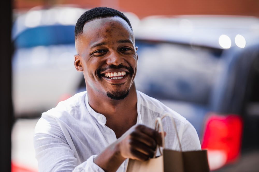 young man smiles during curb side pickup