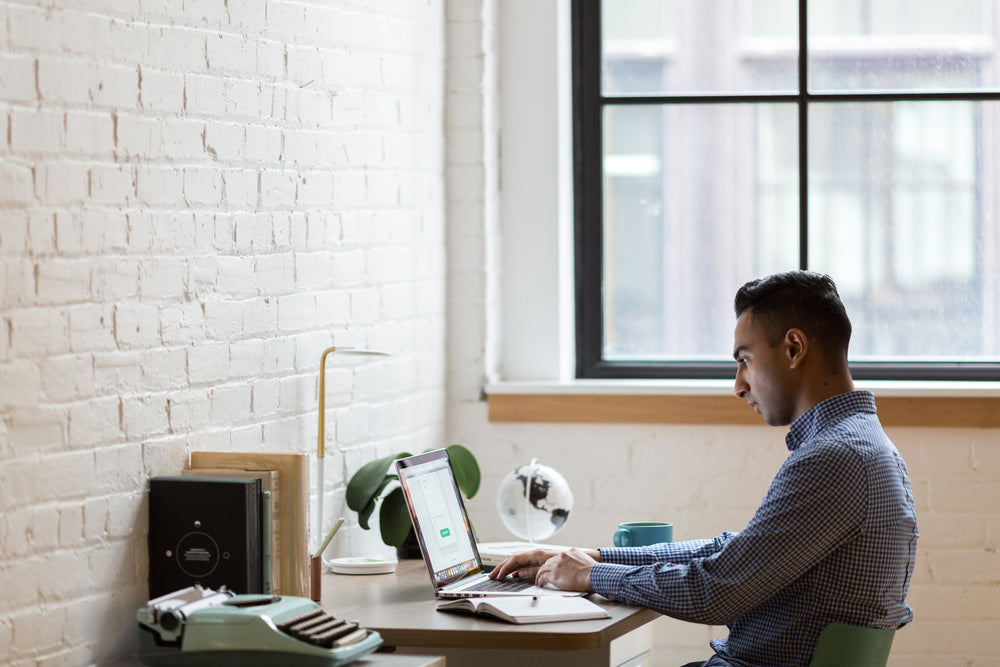 young man working at desk