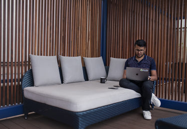 young man working on patio couch