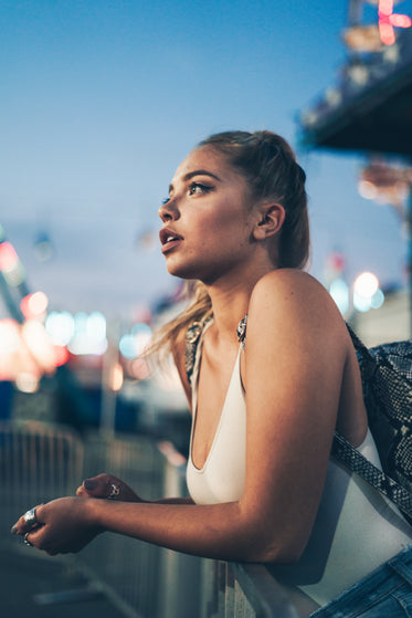 young model leans on fence