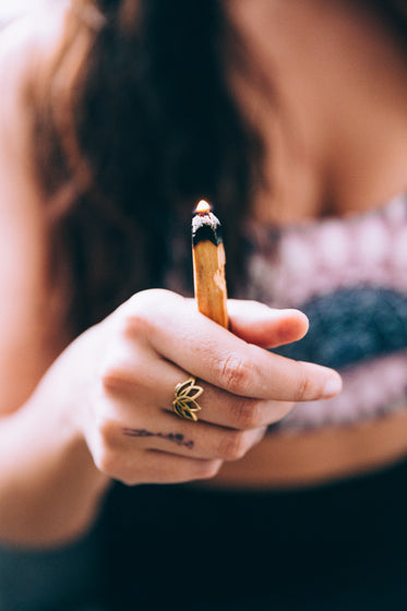 young woman burning sandalwood