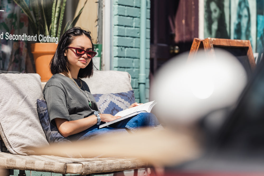 young woman enjoying a book in the sun