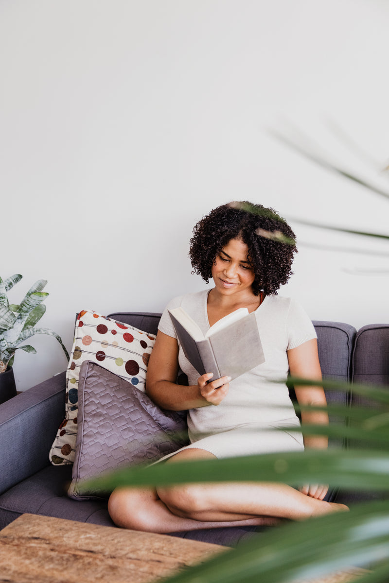 A young woman absorbed in a book
