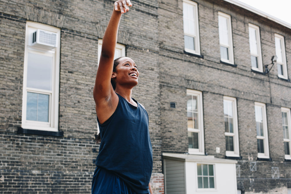 young woman follows through after a jumpshot