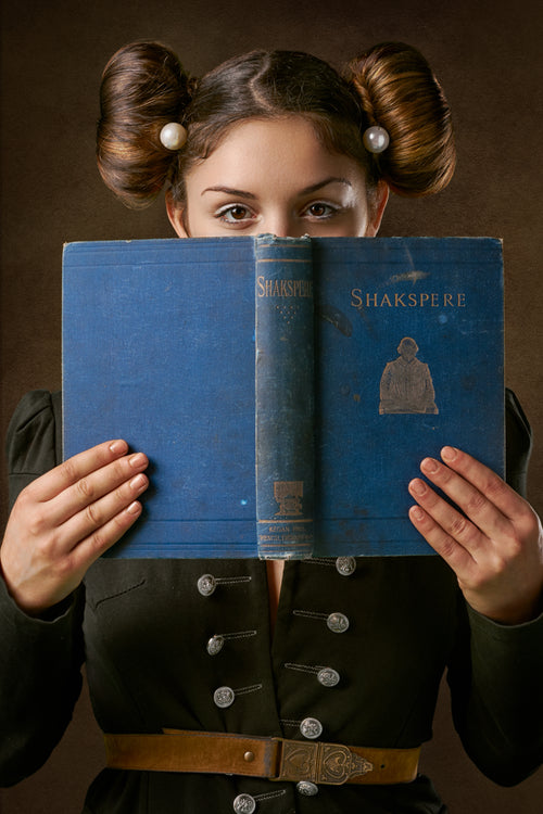 young woman holds an antique book