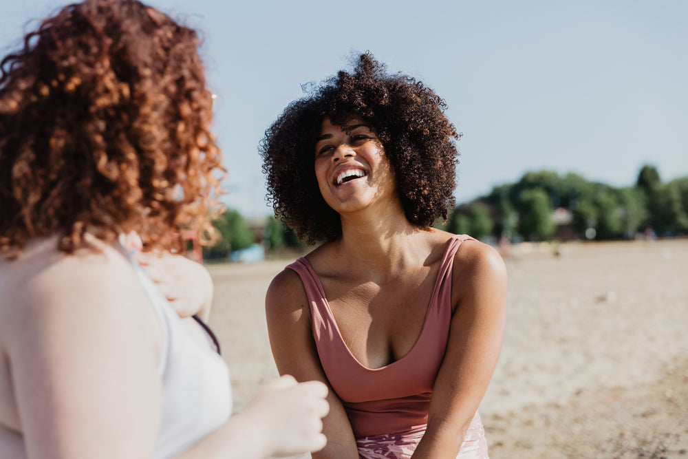 young woman in bikini laughs with friends