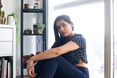 young woman in front of bright window