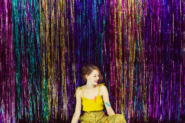 young woman in front of shimmering wall