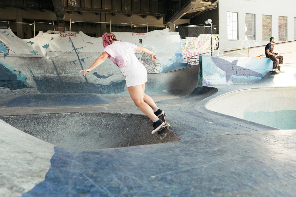 young woman in pink skating a bowl