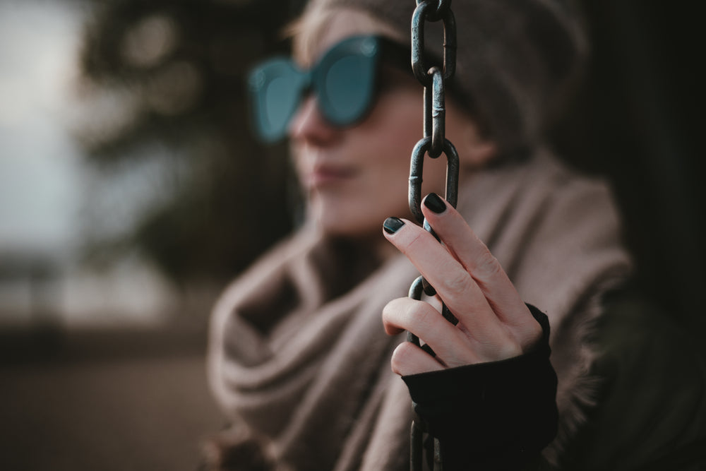 young woman in shades looking into the distance