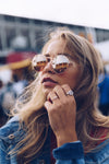 young woman in sunglasses with rings
