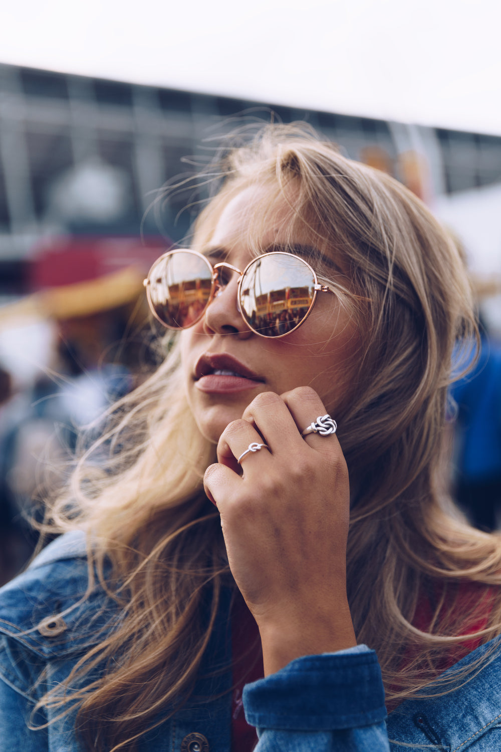 young woman in sunglasses with rings