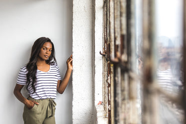 young woman looks to the camera against the industrial decor