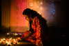 young woman places diwali candles