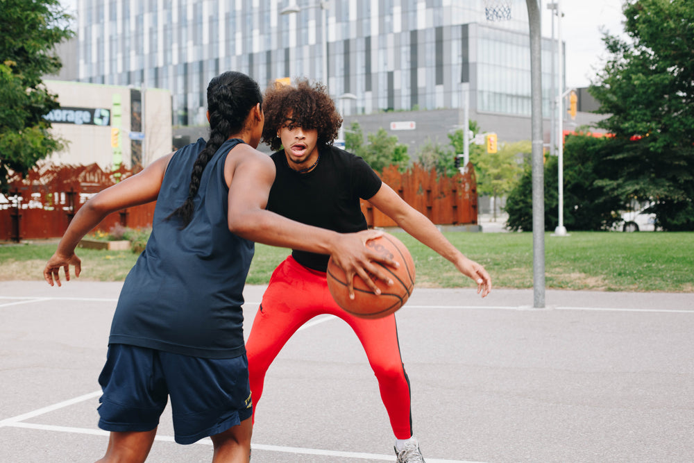 young woman plays basketball