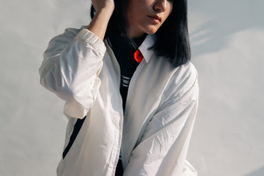 young woman posing in white jacket