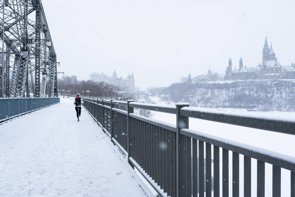 young woman runs through winter season