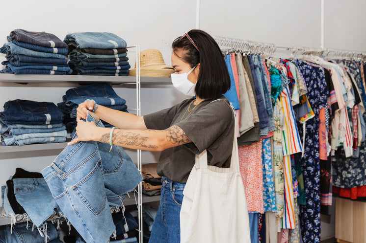 Young Woman Shopping For Clothes With Face Mask On