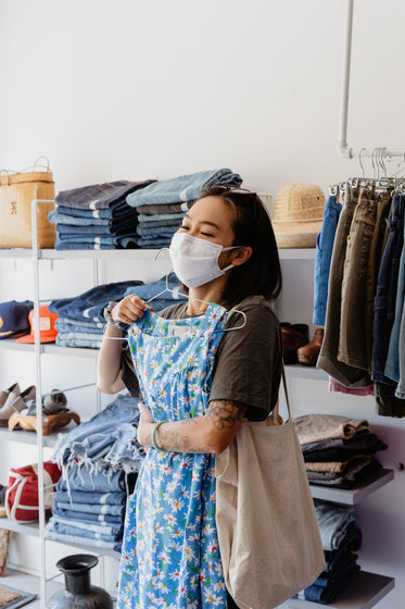 young woman shopping with face mask on