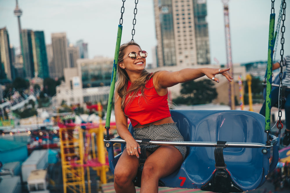 young woman smiling on swing ride