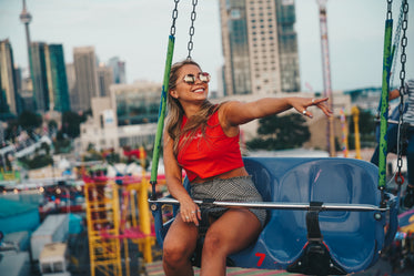 young woman smiling on swing ride