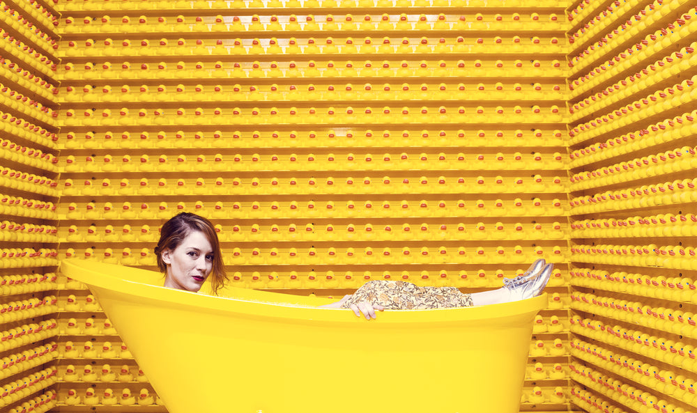 young woman surrounded by rubber ducks