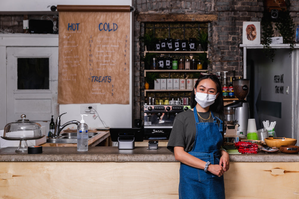 young woman wearing face mask in store