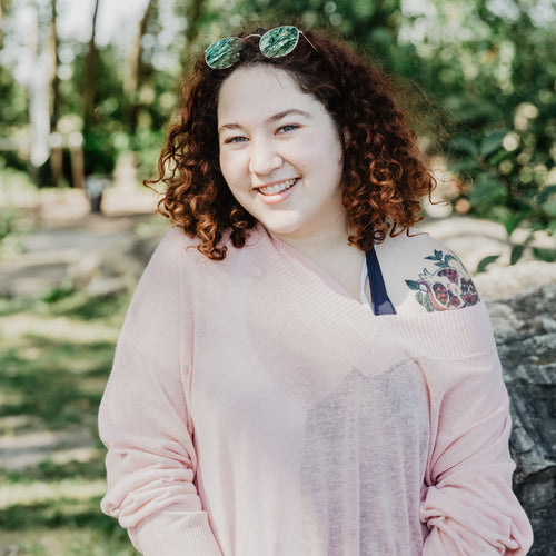 Young Woman With Curly Hair Smiling Bright