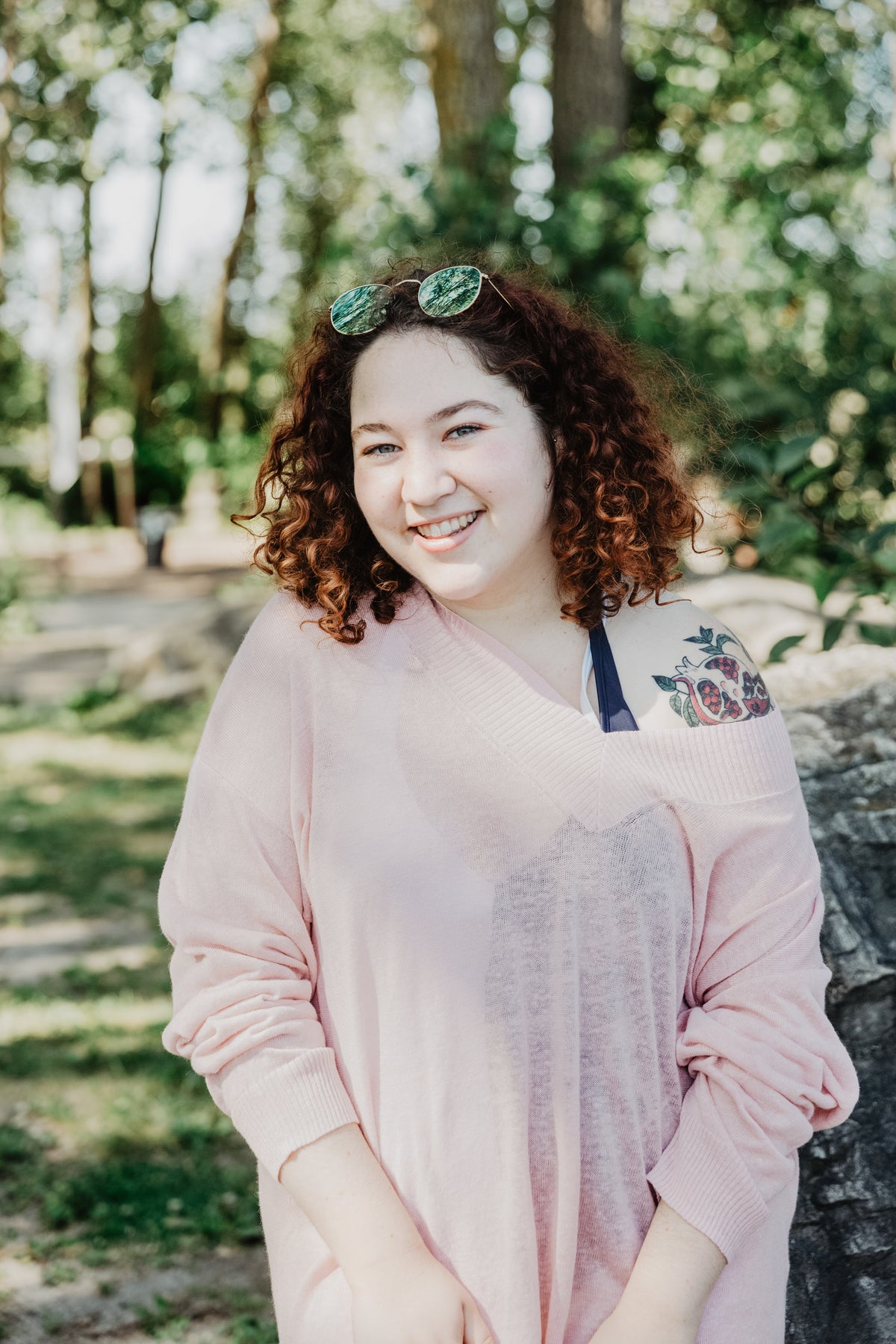 young woman with curly hair smiling bright